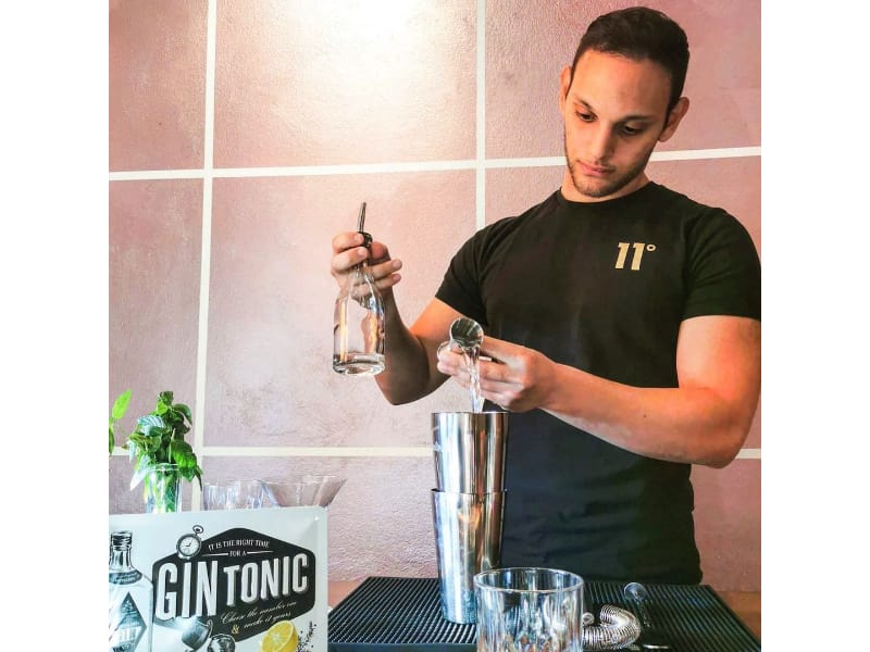 Karim Aly mixing a liquor in a cocktail shaker