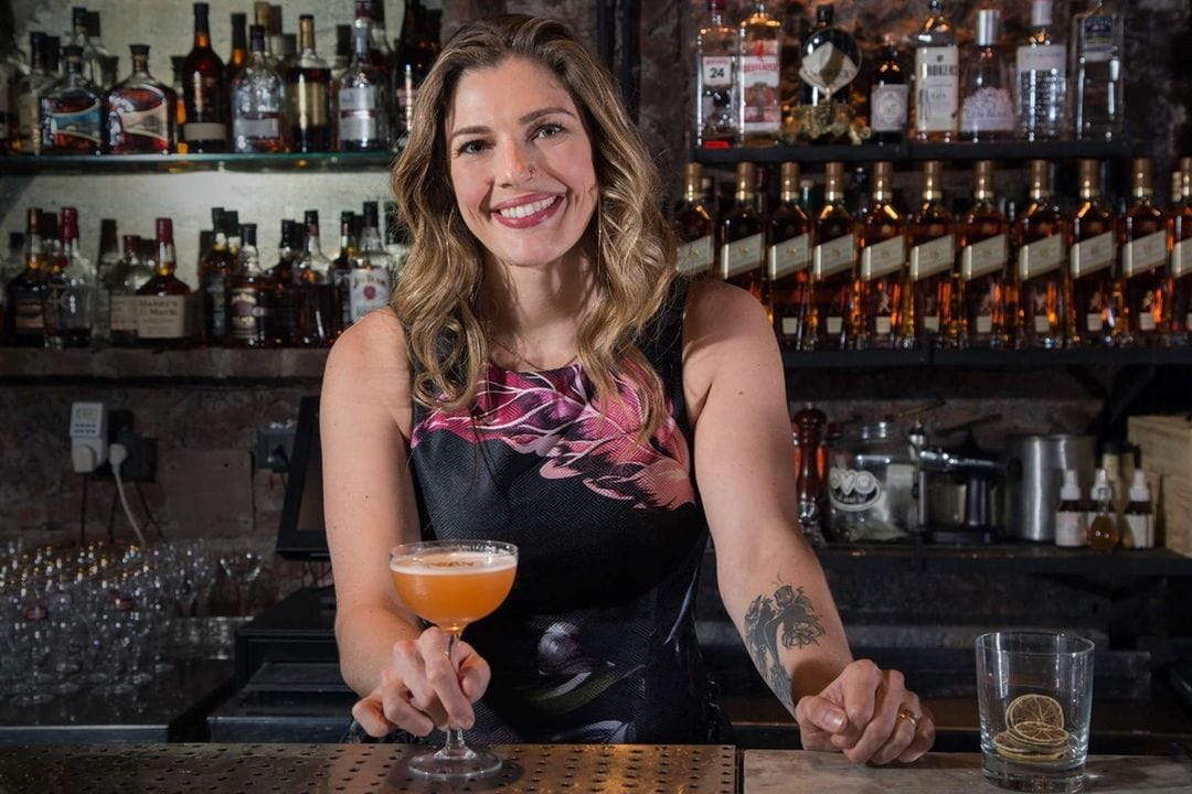 Lauren Mote holding a glass of cocktail