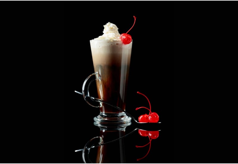 Layered coffee cocktail with whipped cream