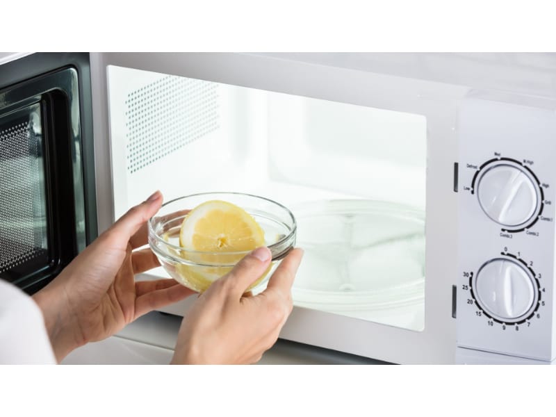  Lemon being placed inside a microwave
