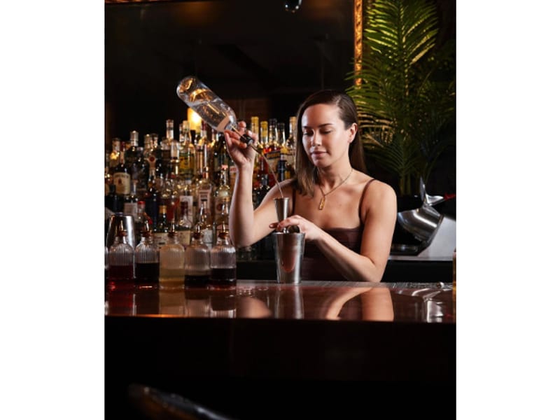  Libby Lingua pouring liquor into a cocktail shaker