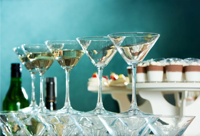 low angle close up shot martini glasses, party table, restaurant dinnerware and glassware