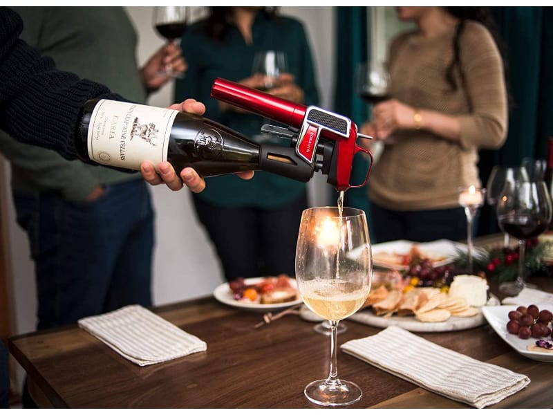 Man pouring wine using Coravin Model Two Elite Pro Wine Preservation System