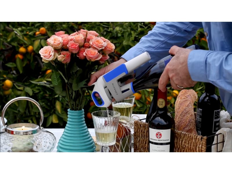 Man pours white wine using Coravin model one