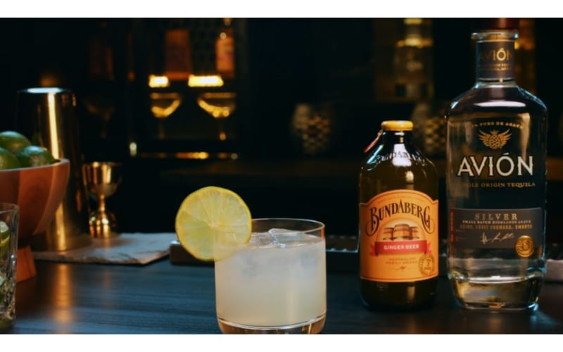 Mexican Tequila Mule with bottles of tequila and ginger beer