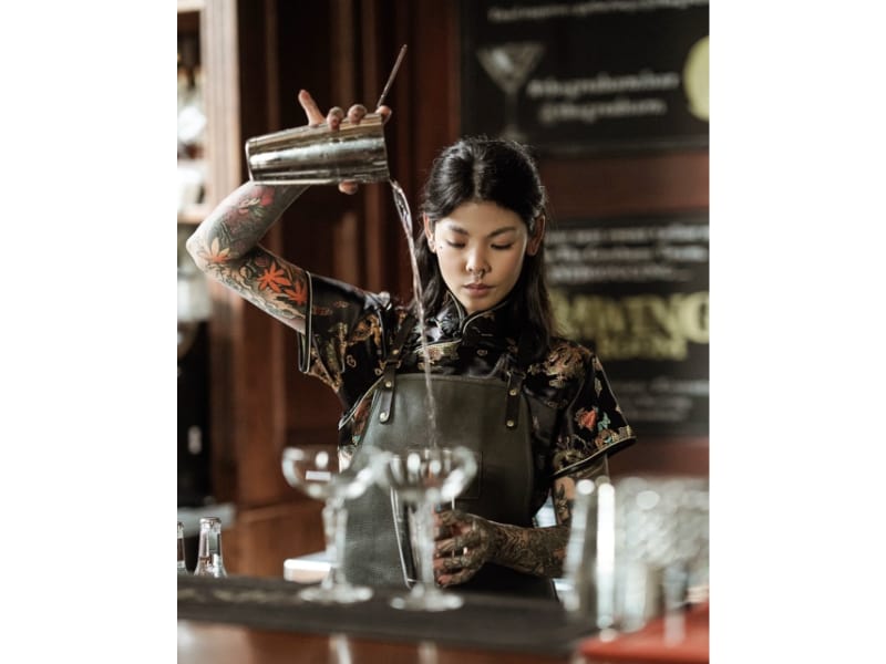  Millie Tang pouring liquor into a glass