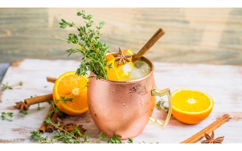 Mule Driver served in a mason jar and garnished with orange, cinnamon stick, and star anise