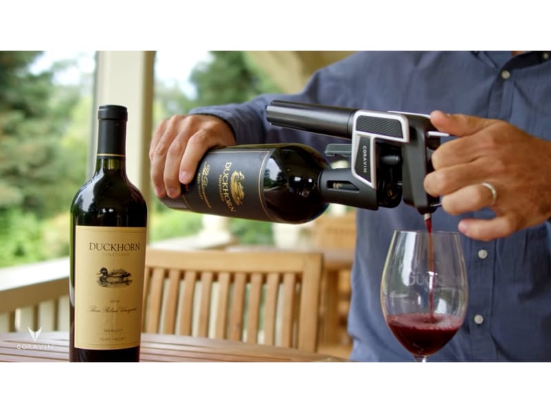 Pouring the bottle of red wine using the Coravin Model Three