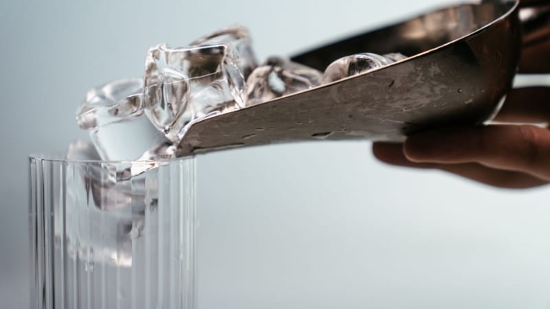 Pouring ice cubes in a glass