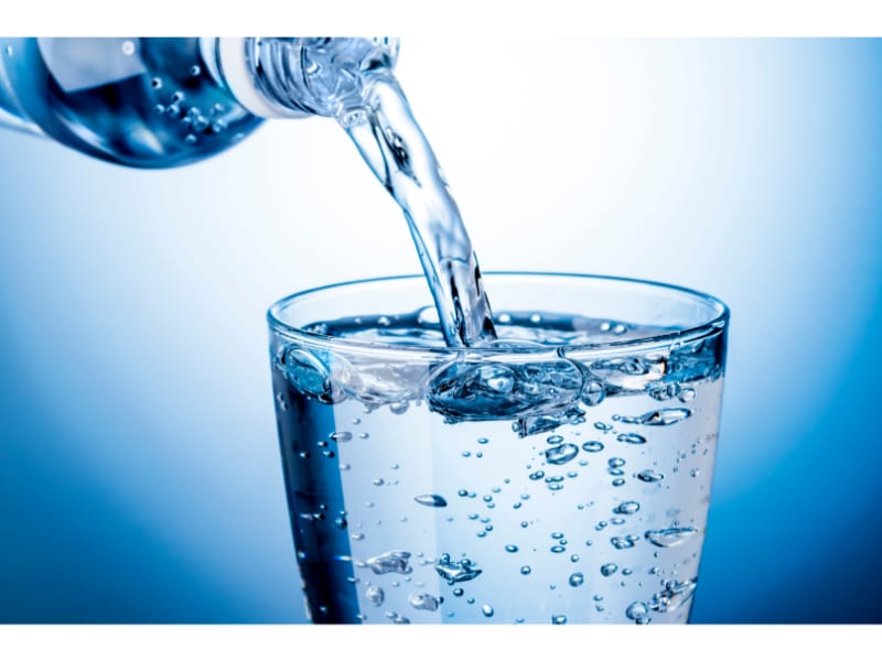 Pouring sparkling water into a glass