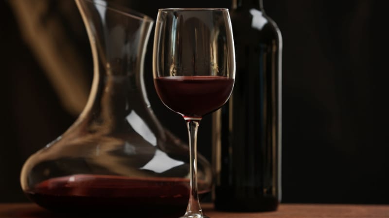 Red wine glass with decanter and bottle
