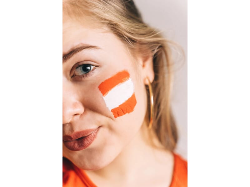 woman with orange and white face paint