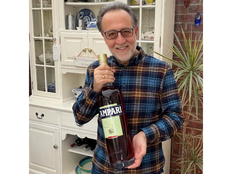 Salvatore Calabrese holding a bottle of wine