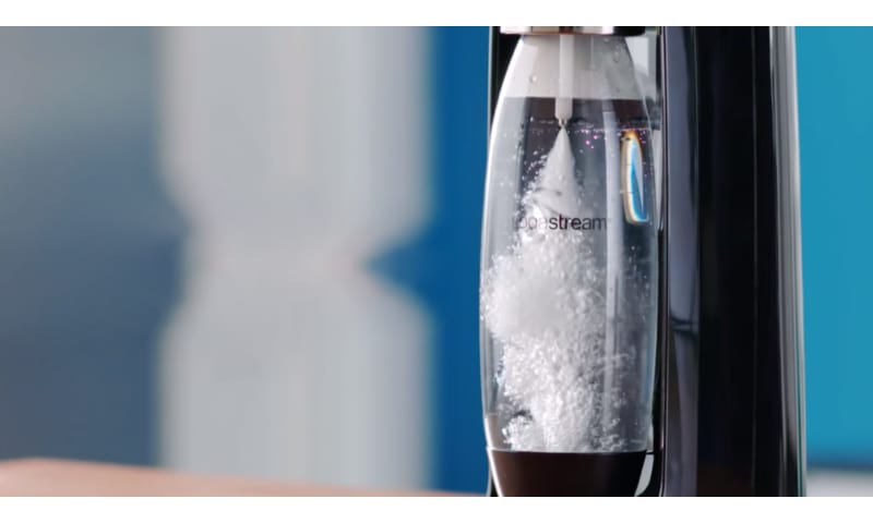 SodaStream bottle in the machine being injected with bubbles