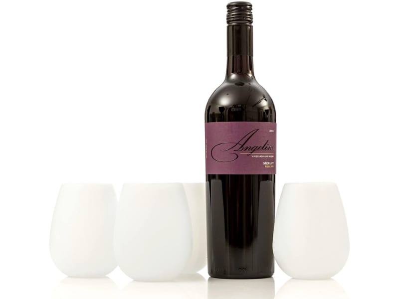 White, stemless silicone wine glasses with a bottle of Merlot wine.