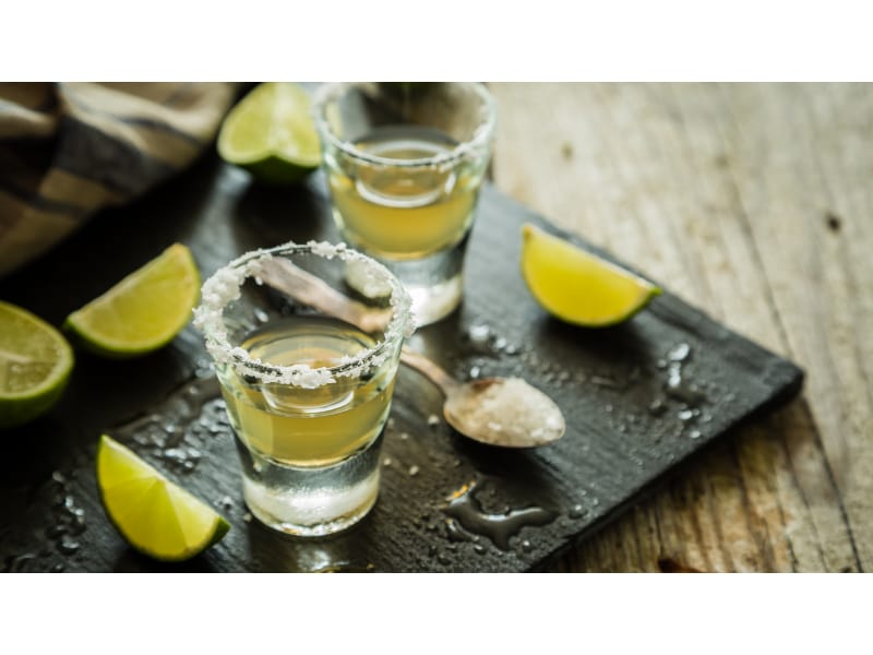 Tequila shots with lime slices and salt