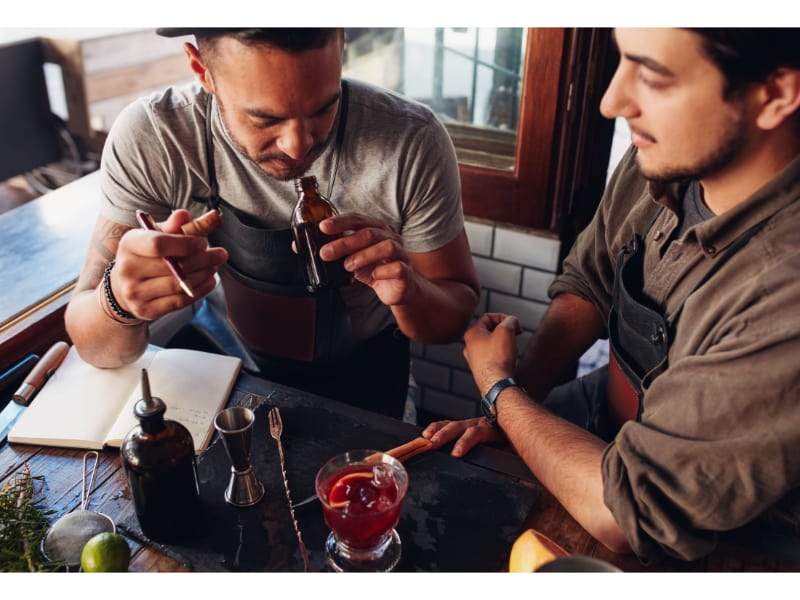 Two Bartenders Experimenting with Creating Cocktails