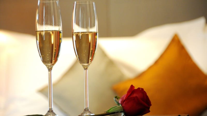 Two champagne flute glasses with rose