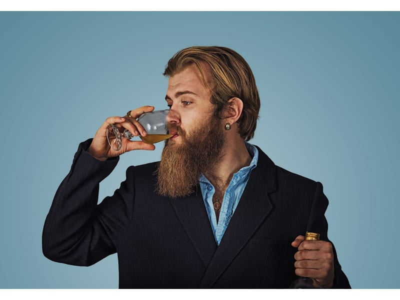 Man drinking whiskey from a glass