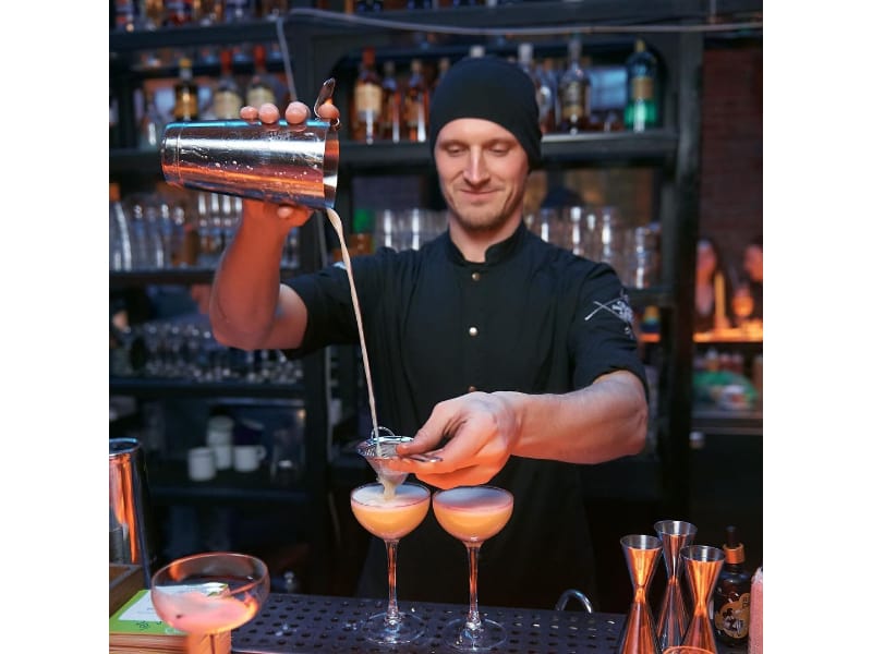  Vitaly Kolpin pouring liquor into a glass