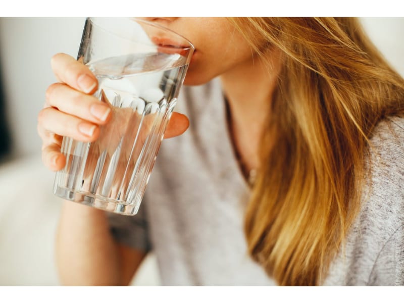 Girl sipping a glass of water