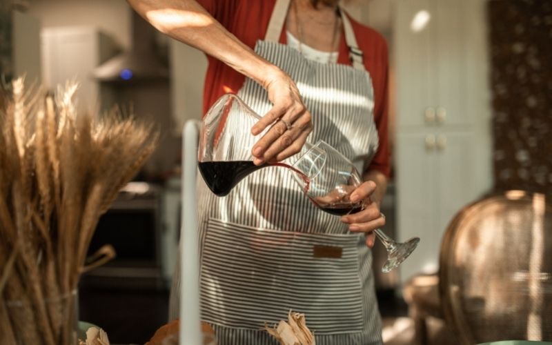 A person decanting wine