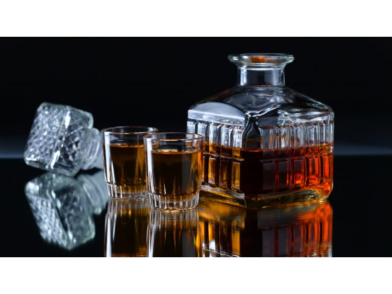 Whiskey in a crystal decanter with whiskey glasses