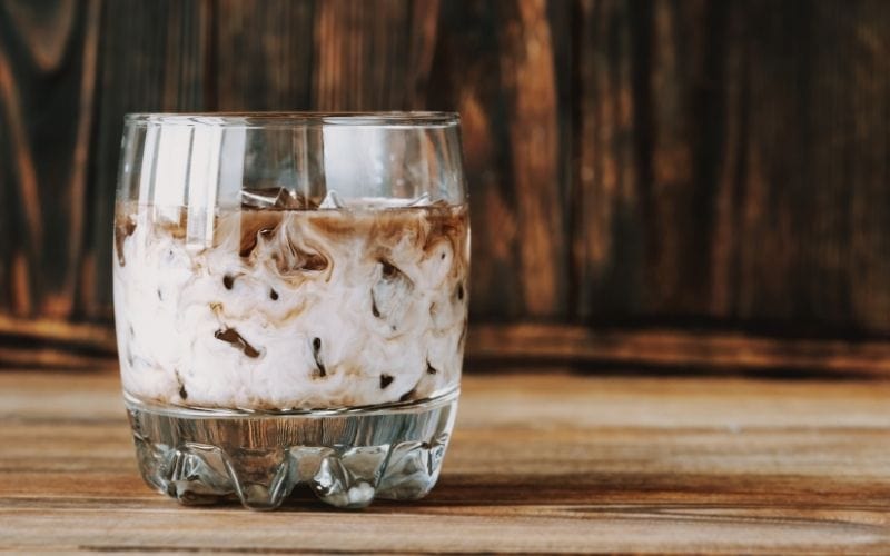 A glass of White Russian on a Rustic Table