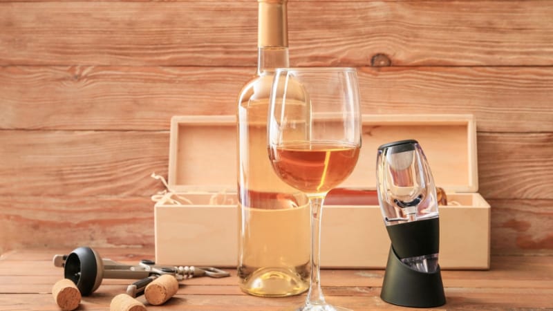 Wine aerator with a glass of wine and a storage box