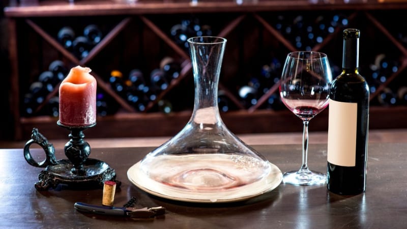 Wine decanter with wine glass and bottle of wine