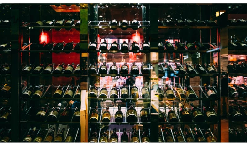 Red wine bottles on a shelf
