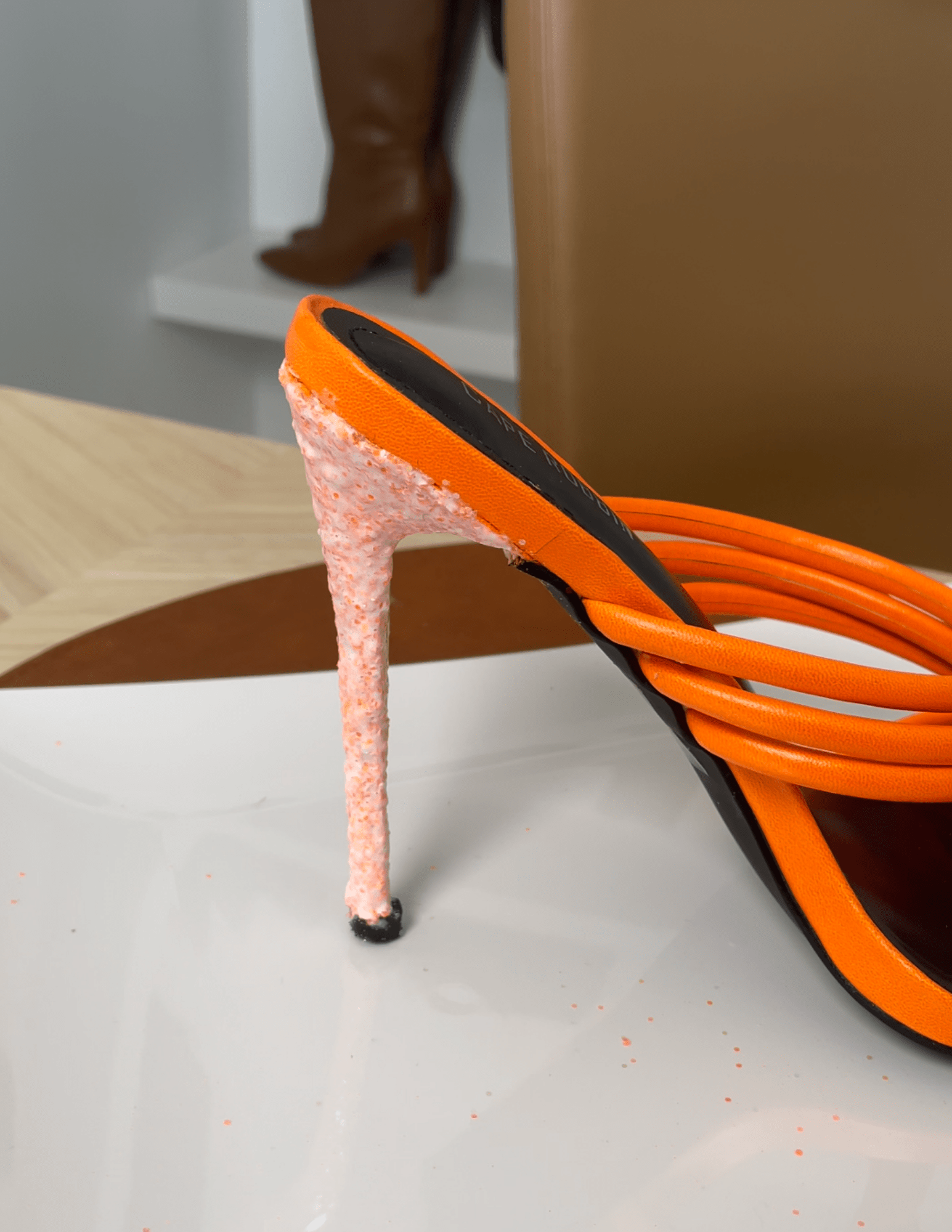close up of the orange heel with modge podge coat on glitter