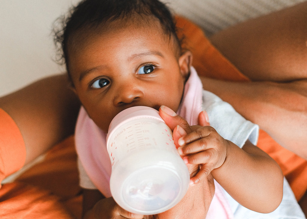 3 month old baby feeding from a bottle