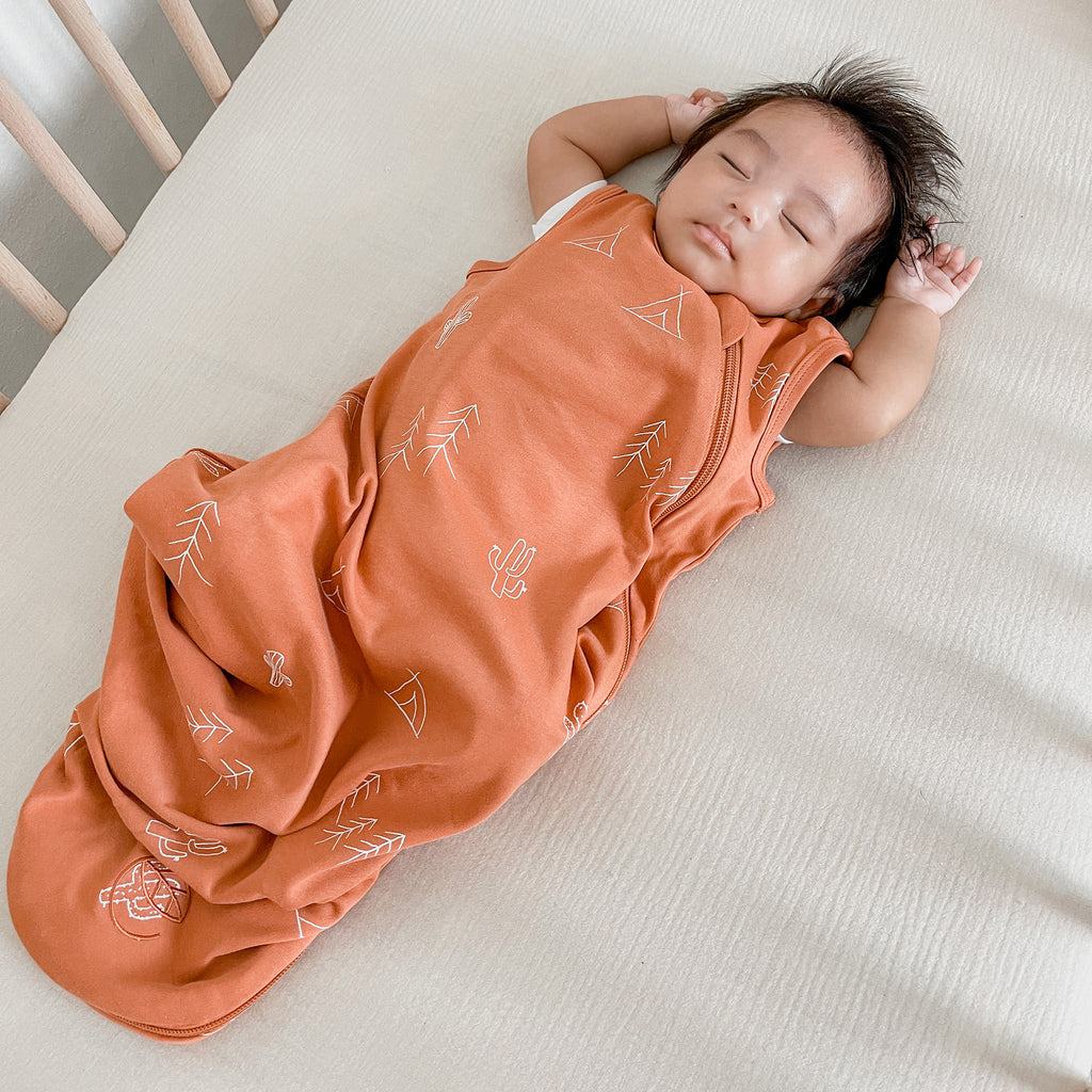 Baby sleeping on back in crib wearing an Ecolino organic cotton sleep sack, How to Keep Your Baby Warm at Night