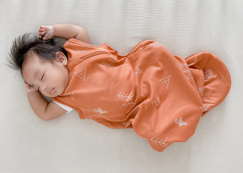 Baby sleeping peacefully in a Ecolino® Basic Organic Cotton Baby Sleep Bag in Desert print