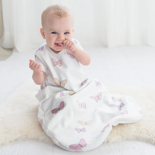 Baby sucking thumb while wearing a Woolino 4 Season Basic Baby sleep bag in Butterfly print