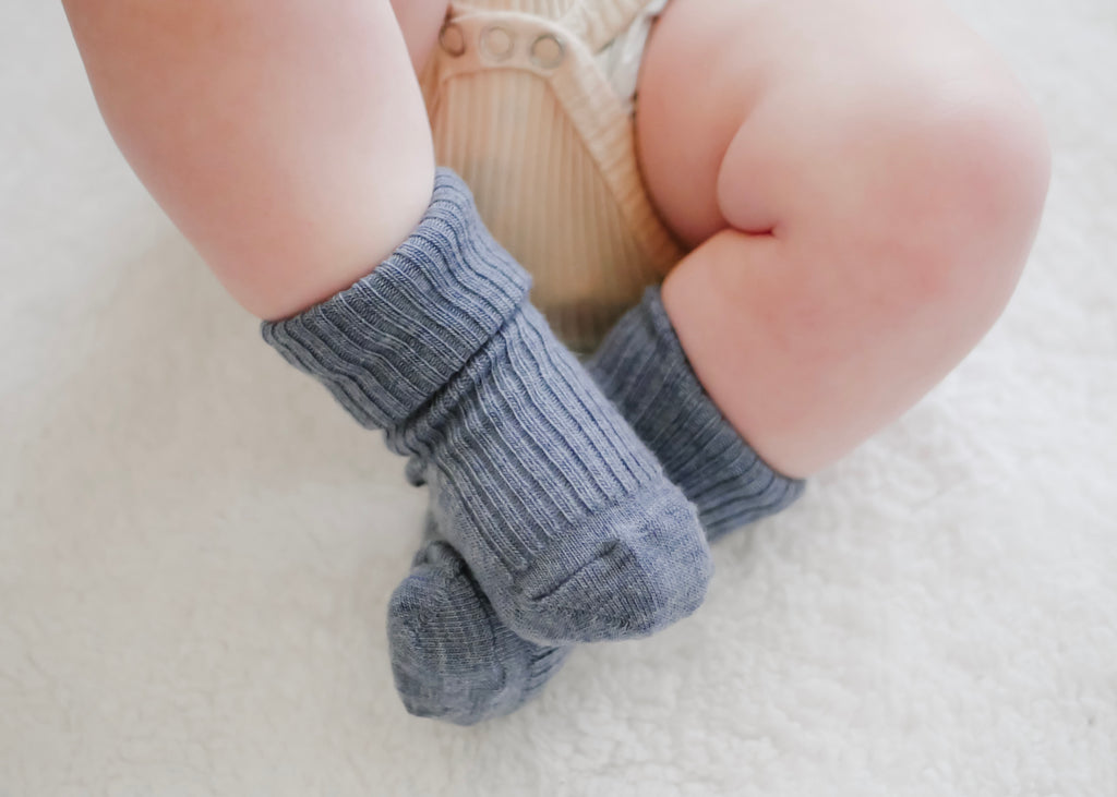 Cute baby feet wearing blue Woolino Merino Wool Socks