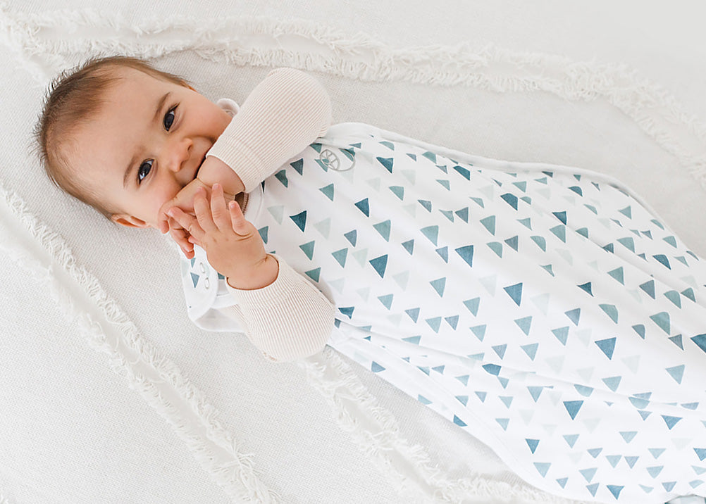 Happy baby wearing a Woolino 4 Season Ultimate Baby Sleep Sack