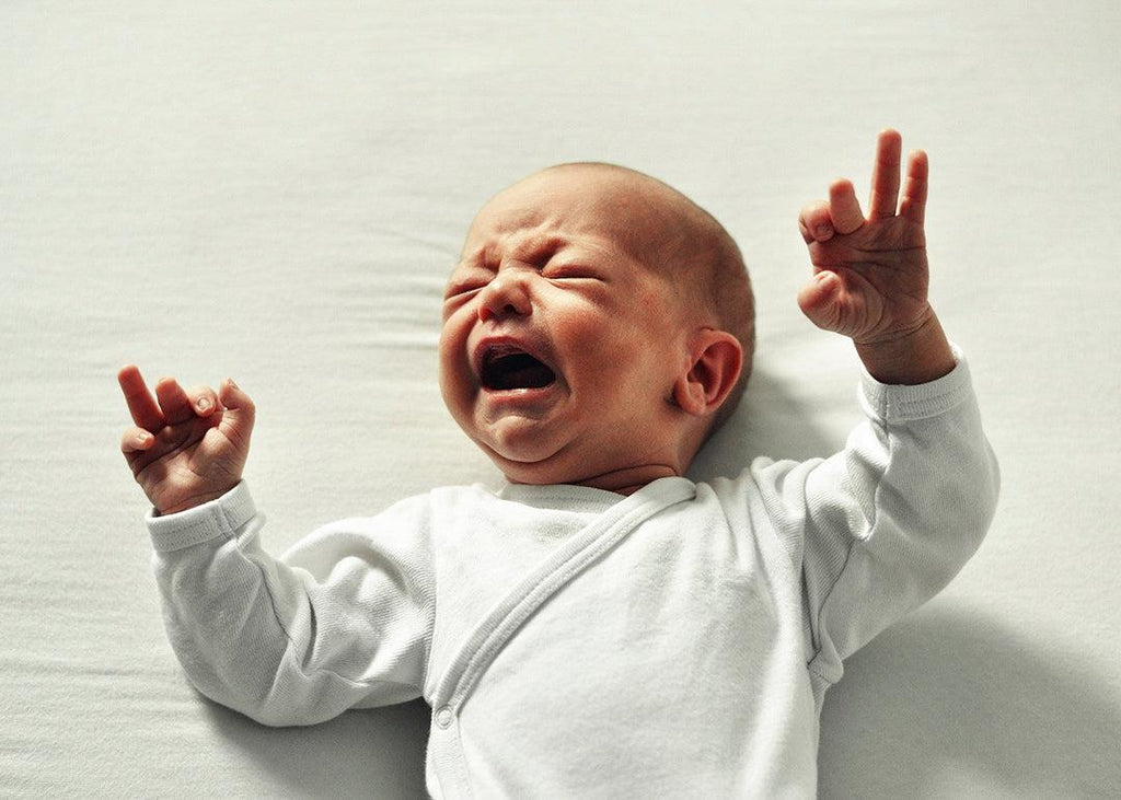 Main blog image for Tips to Deal with Baby's Witching Hour depicting newborn baby crying