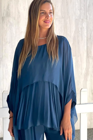 Woman wearing a blue 100% silk top from Pizazz Boutique Nelson Bay NSW dress shops