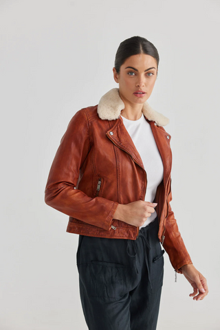 Woman wearing a leather jacket by The Shanty Corporation