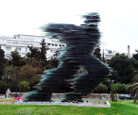 running man statue contemporary city statue in athens greece in front of hilton