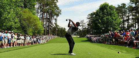 golfer in mid swing at the US Masters