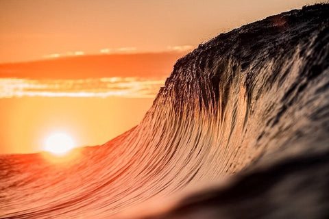 Wave cresting during sunset by Lloyd Meudell