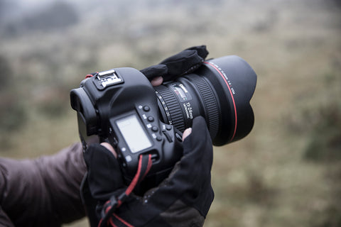 AquaTech sensory gloves holding a camera