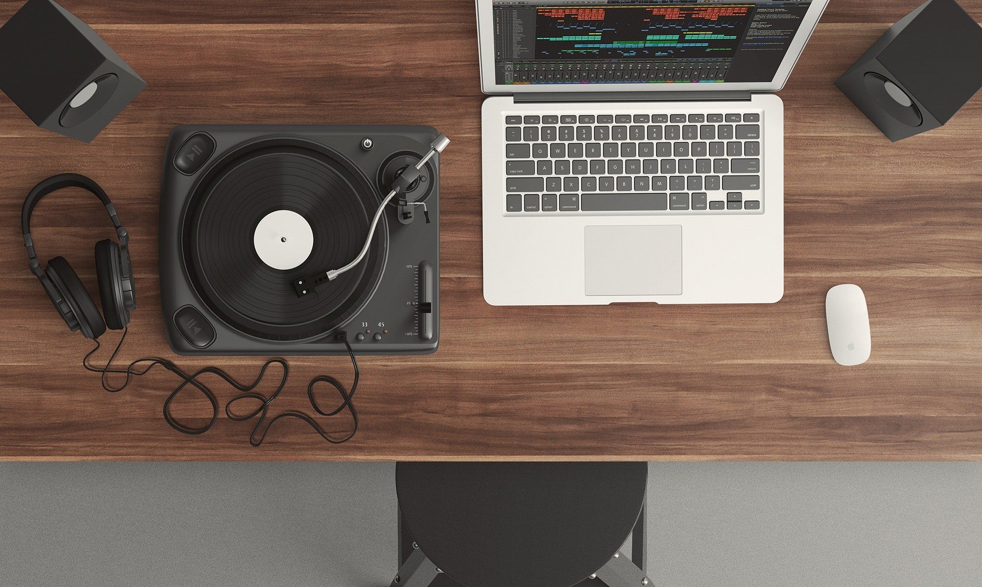 Turntable playing music on top of a dark wooden desk.