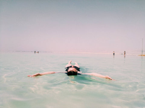 Woman floating in the Dead Sea