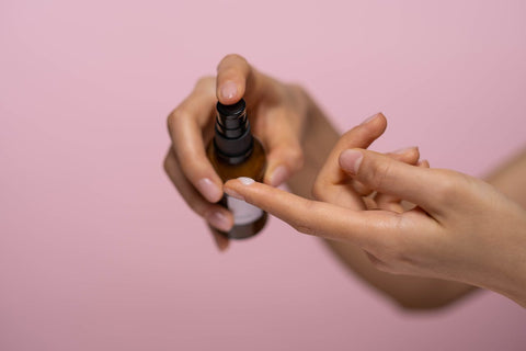person holding and put on hand face serum
