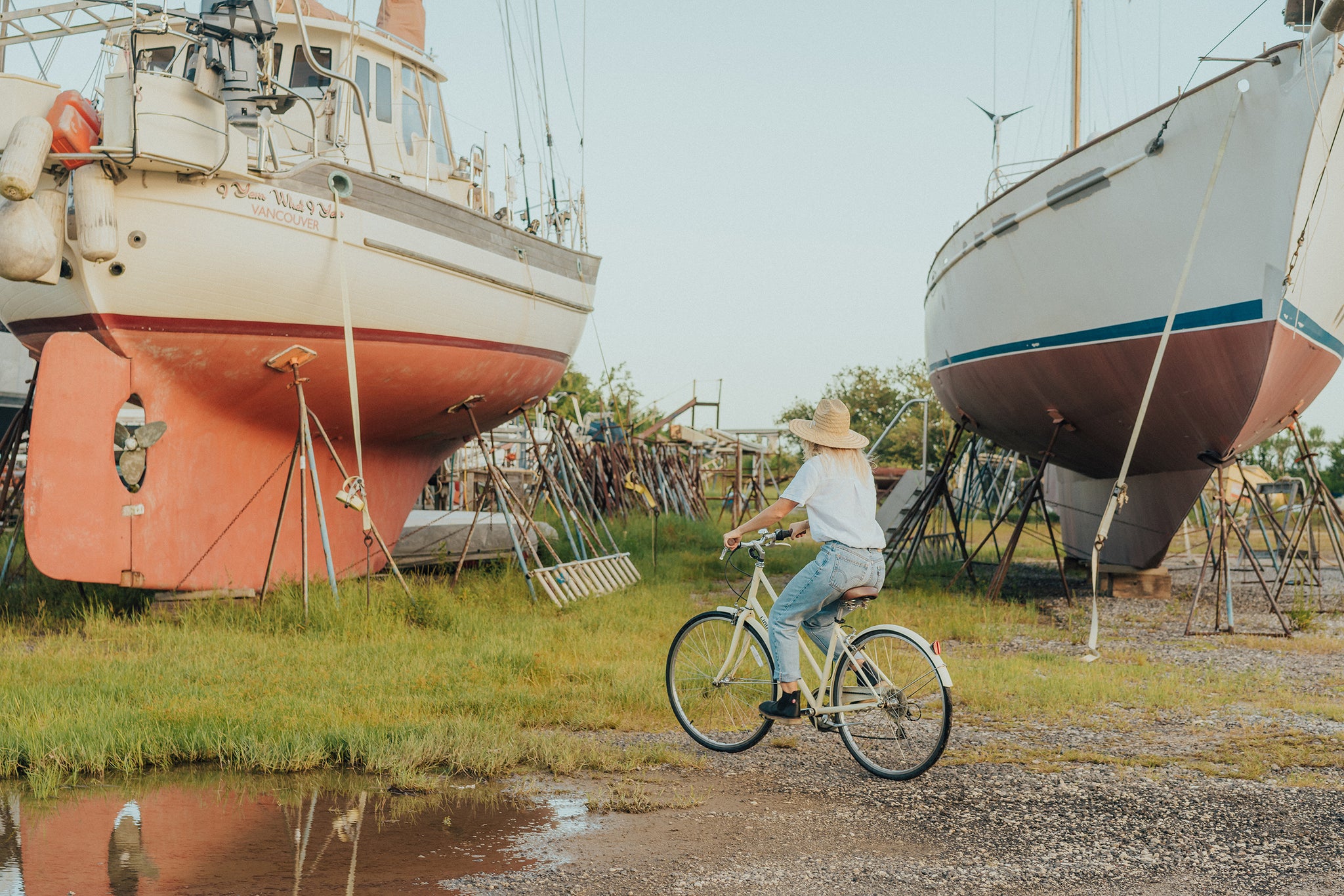 Laerke riding bike in boat yard wearing Roskilde Black