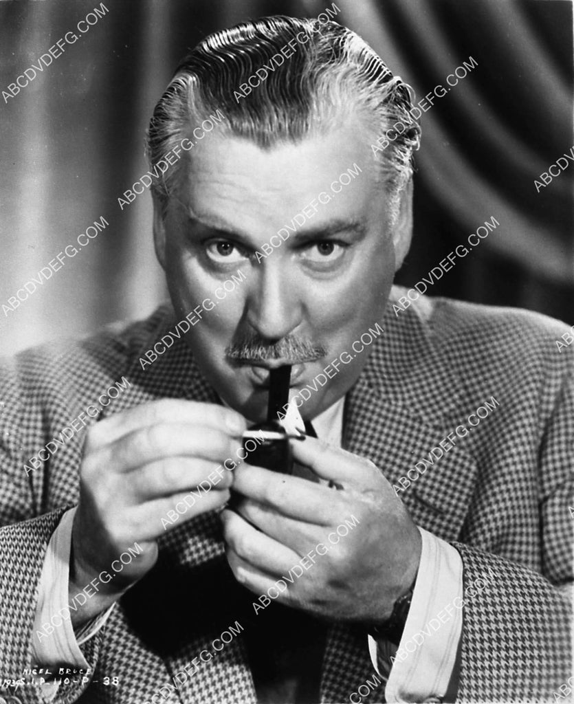 Nigel Bruce lighting his pipe film Rebecca 1939-32 – ABCDVDVIDEO